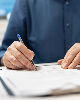 Advisor helping a client with financial and legal paperwork, representing permit and documentation assistance
